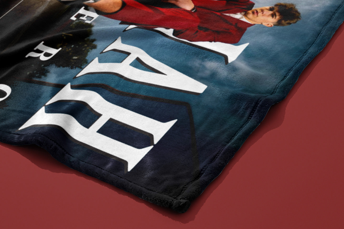 Close-up of a blue fabric with large white letters on a red surface