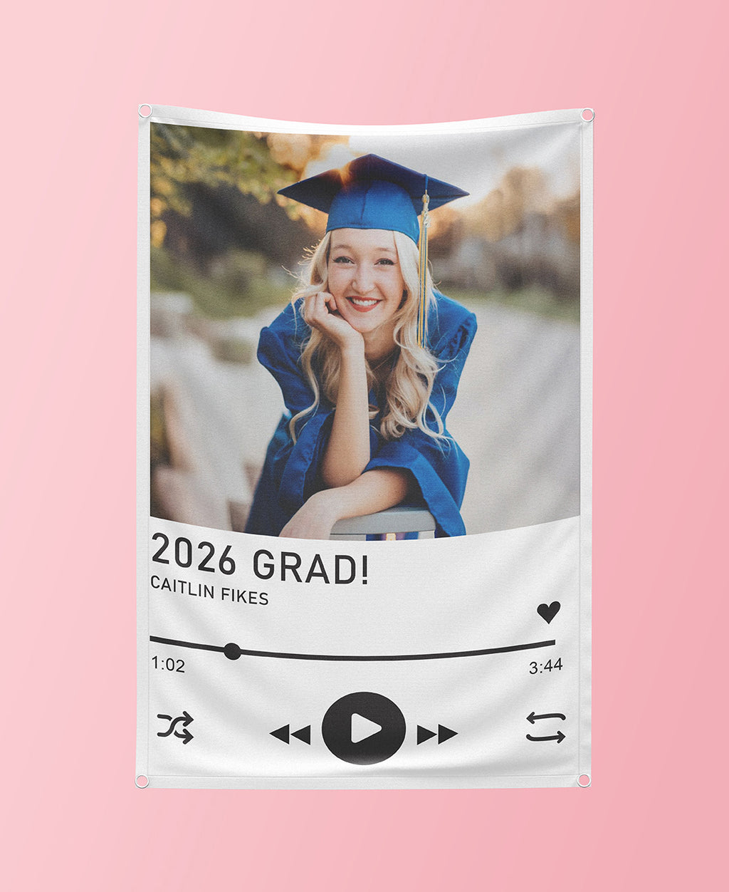 Graduation-themed decorative banner with a photo of a graduate and '2026 GRAD!' text on a pink background.