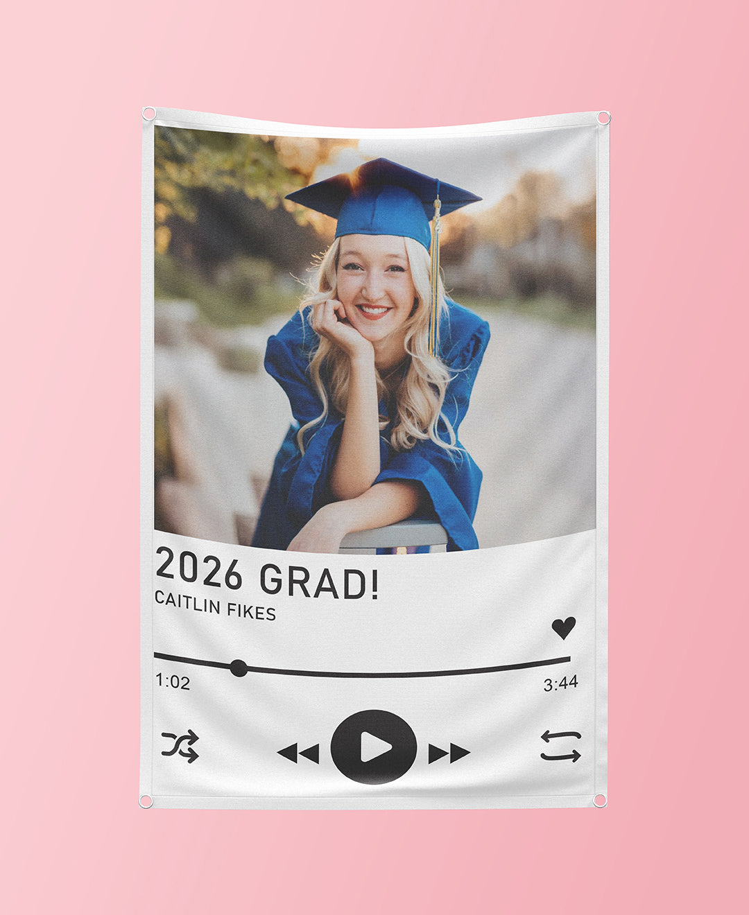 Graduation-themed decorative banner with a photo of a graduate and '2026 GRAD!' text on a pink background.