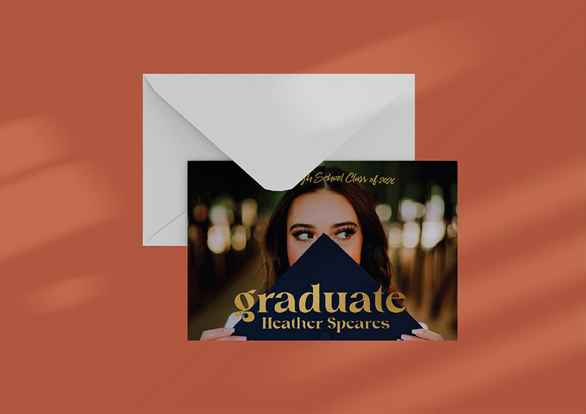 Graduation invitation with envelope on a warm brown background