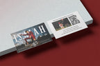 Two promotional cards on a red and gray surface