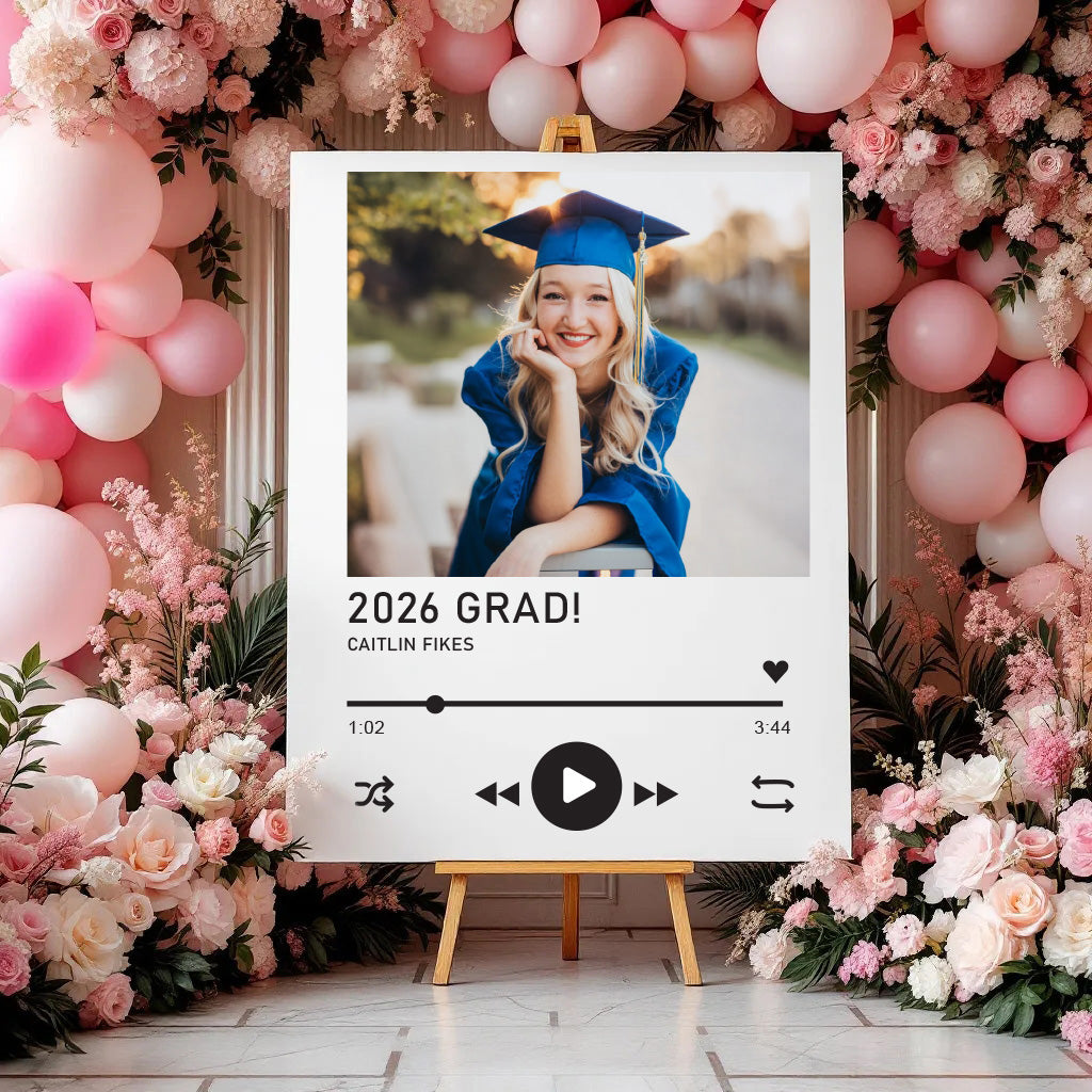 Graduation-themed photo display with balloons and flowers, featuring a photo of a graduate.