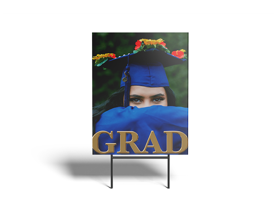 Graduation-themed standee with a person in a blue cap and gown, holding a 'GRAD' sign.
