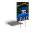 Graduation-themed outdoor sign with a person in a blue graduation gown and cap.