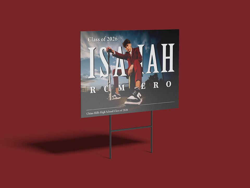 Graduation sign with a student in a cap and gown against a scenic background on a red background